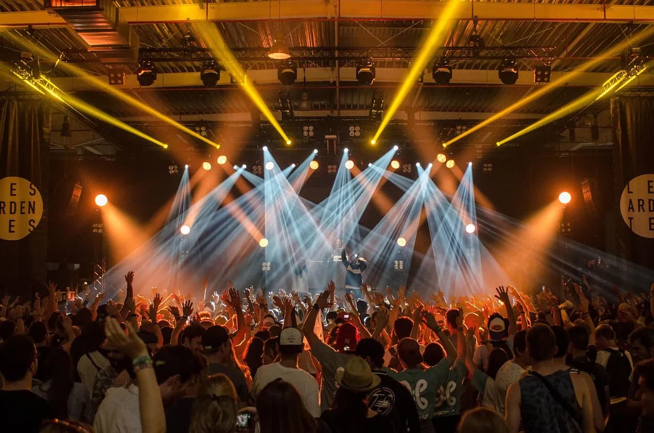 A concert crowd in front of a lit stage