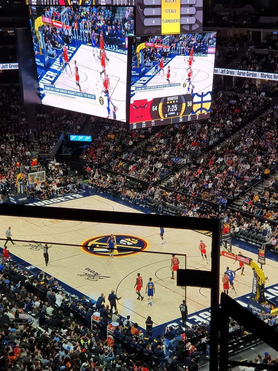 A basketball court surrounded by a full crowd