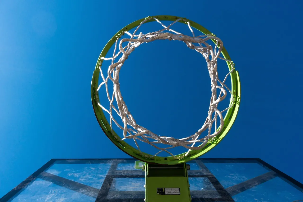 A basketball hoop against a blue sky