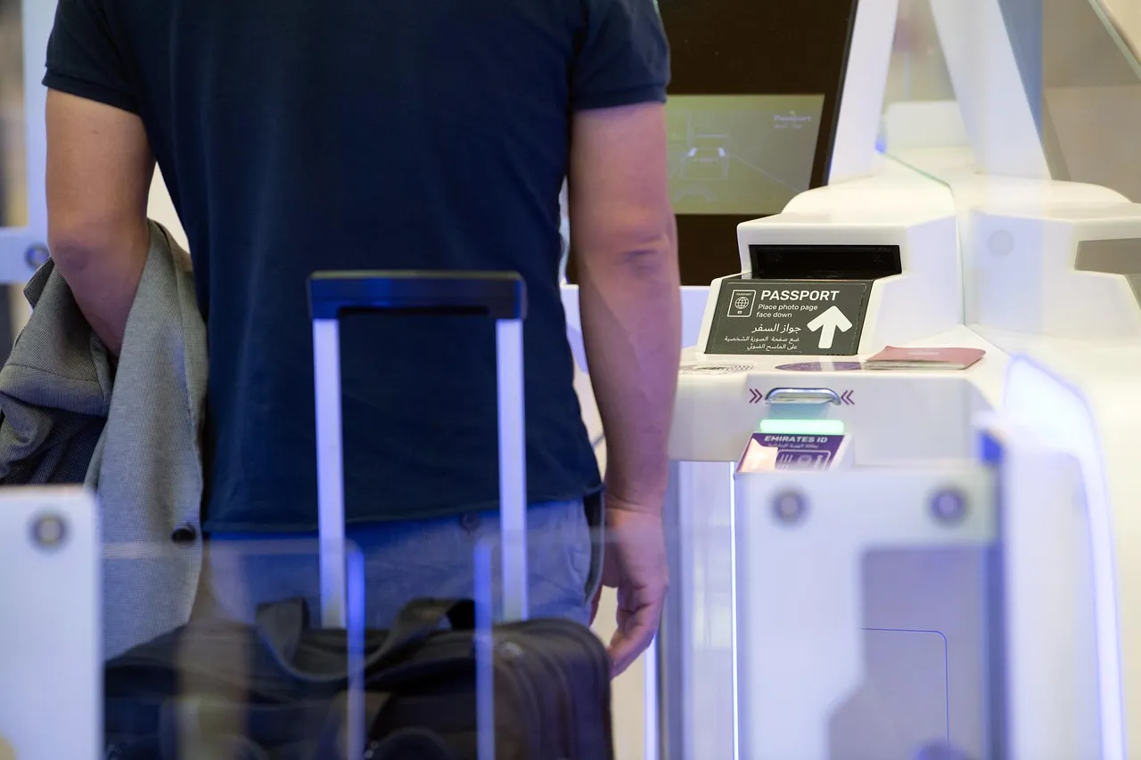 A traveler with a suitcase at an airport boarding gate